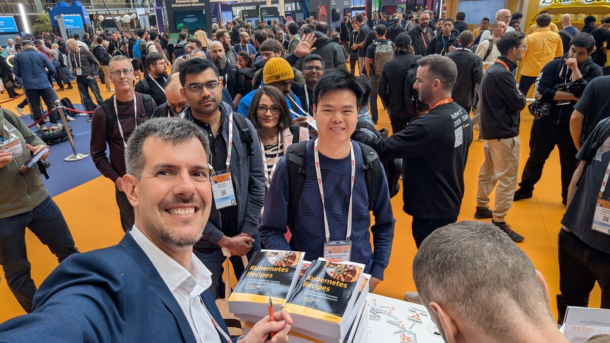 Crowd at Kubernetes Recipes book signing at KubeCon EU 2026 Amsterdam expo floor
